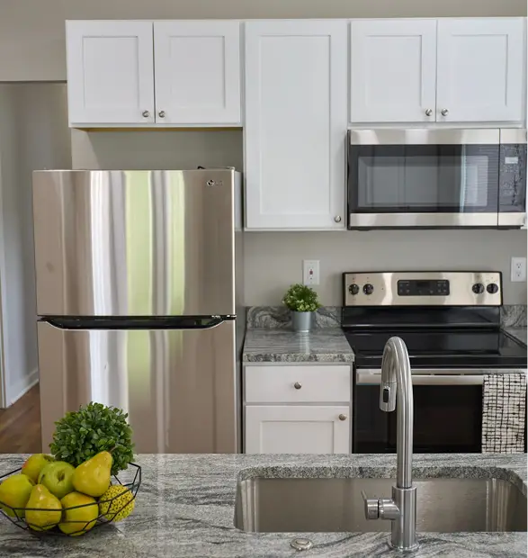Renovated Marston Street kitchen with white cabinets, stainless-steel appliances and island
