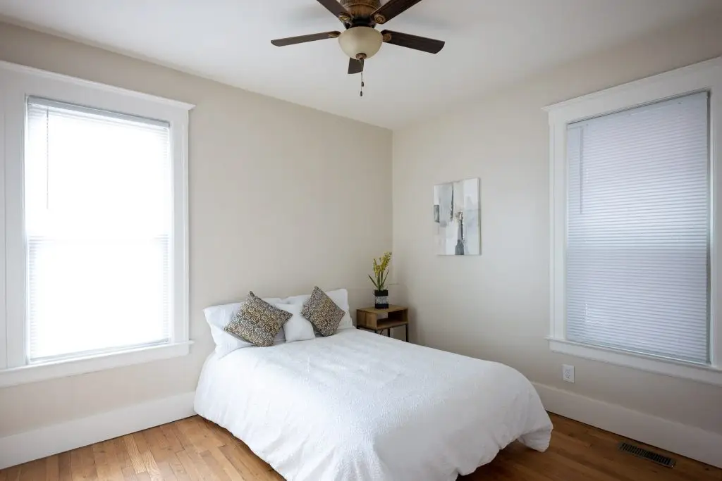 Bright bedroom with original hardwood floors at a Virginia Park apartment near Henry Ford Hospital